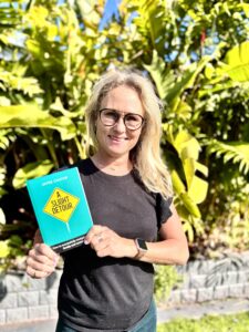 Jayne Chater smiling and holding her book A Slight Detour