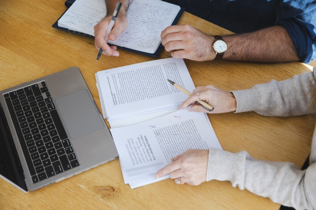 A book editor writing comments on a manuscript.